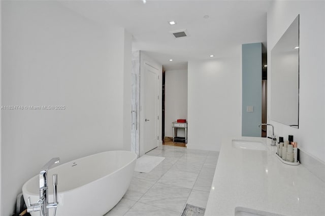 718 Valencia Ave Unit 204, Coral Gables, FL 33134 - bathroom with double vanity, a freestanding tub, marble finish flooring, and recessed lighting