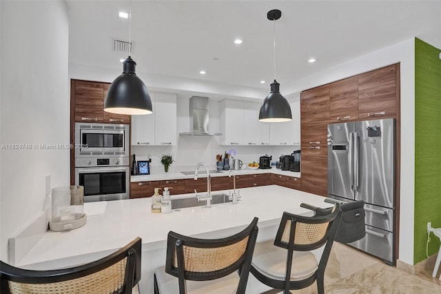 718 Valencia Ave Unit 204, Coral Gables, FL 33134 - kitchen featuring appliances with stainless steel finishes, wall chimney exhaust hood, modern cabinets, light countertops, and white cabinets