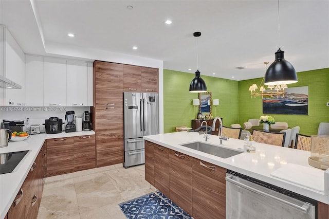 718 Valencia Ave Unit 204, Coral Gables, FL 33134 - kitchen with stainless steel appliances, brown cabinets, white cabinets, and recessed lighting