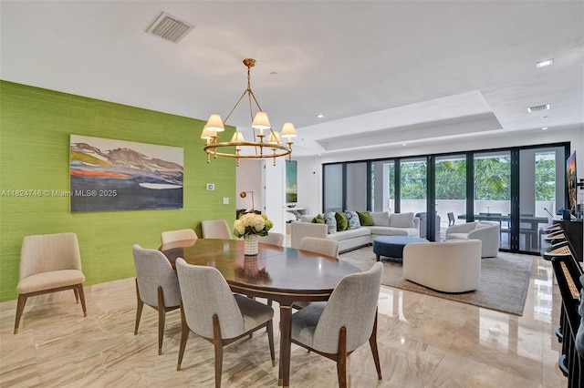 718 Valencia Ave Unit 204, Coral Gables, FL 33134 - dining room with light marble finish floors, a chandelier, and a raised ceiling