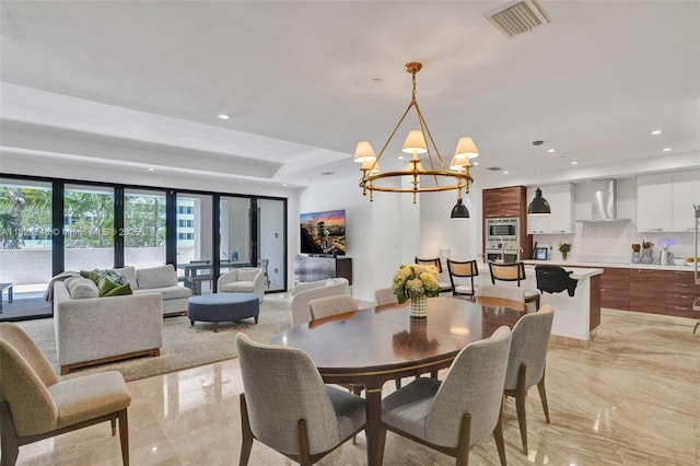 718 Valencia Ave Unit 204, Coral Gables, FL 33134 - dining space featuring light marble finish floors, a chandelier, and recessed lighting