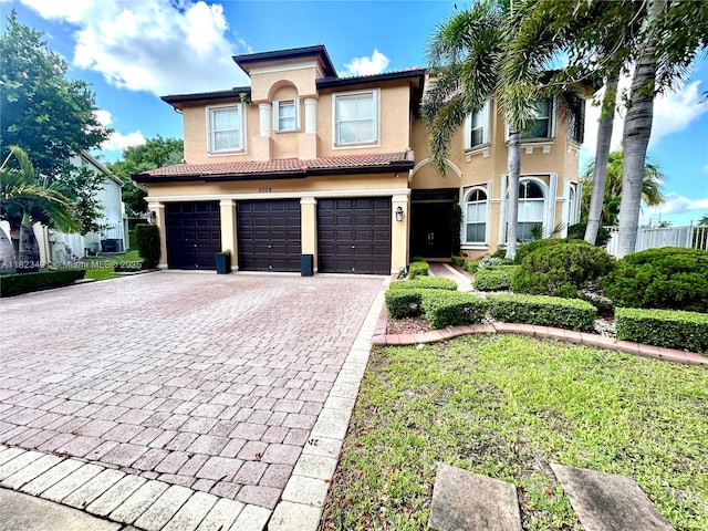 5058 SW 170th Ave, Miramar, FL 33027 - view of front of house featuring an attached garage, decorative driveway, and stucco siding