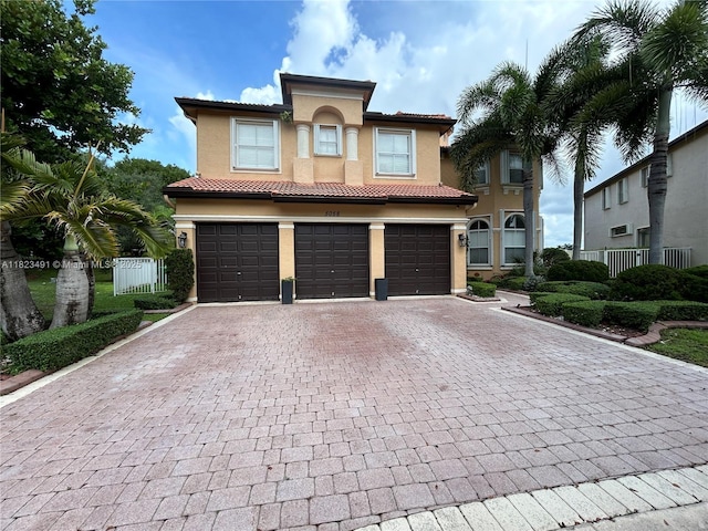 5058 SW 170th Ave, Miramar, FL 33027 - mediterranean / spanish-style house featuring a garage, decorative driveway, stucco siding, and a tile roof