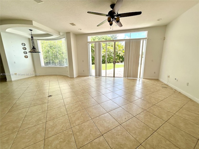 5058 SW 170th Ave, Miramar, FL 33027 - unfurnished room featuring light tile patterned flooring, a ceiling fan, arched walkways, and a textured ceiling