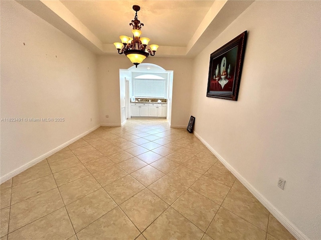 5058 SW 170th Ave, Miramar, FL 33027 - unfurnished room with a chandelier, a tray ceiling, and light tile patterned floors