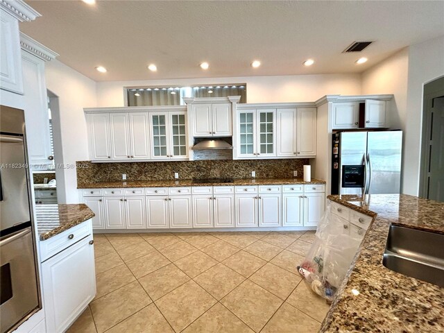 5058 SW 170th Ave, Miramar, FL 33027 - kitchen featuring stainless steel fridge with ice dispenser, under cabinet range hood, backsplash, black electric cooktop, and glass insert cabinets