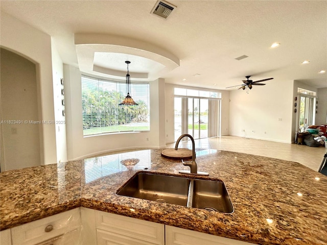 5058 SW 170th Ave, Miramar, FL 33027 - kitchen featuring open floor plan, dark stone counters, white cabinets, ceiling fan, and recessed lighting