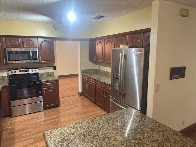 2660 Huron Way, Miramar, FL 33025 - kitchen with appliances with stainless steel finishes, light wood-style flooring, a textured ceiling, and dark brown cabinetry