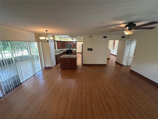 2660 Huron Way, Miramar, FL 33025 - unfurnished living room featuring a chandelier, dark wood-style flooring, a textured ceiling, and a ceiling fan