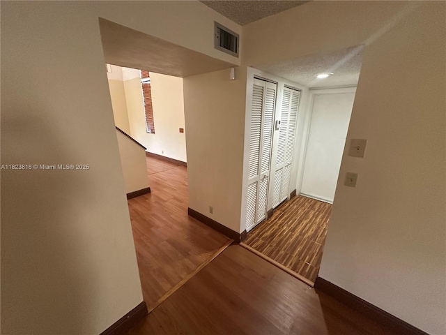 2660 Huron Way, Miramar, FL 33025 - hallway with wood finished floors and a textured ceiling