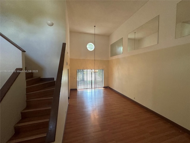 2660 Huron Way, Miramar, FL 33025 - staircase featuring a towering ceiling, wood finished floors, and a chandelier