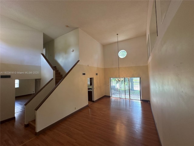 2660 Huron Way, Miramar, FL 33025 - unfurnished living room with a towering ceiling, a chandelier, wood finished floors, and stairs