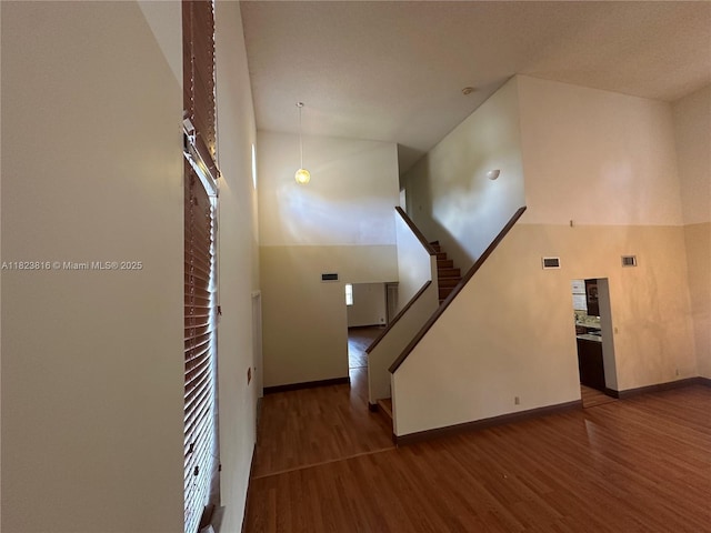 2660 Huron Way, Miramar, FL 33025 - unfurnished living room featuring wood finished floors, a towering ceiling, and stairs