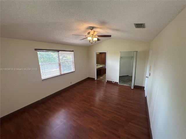 2660 Huron Way, Miramar, FL 33025 - unfurnished bedroom with dark wood-type flooring, a textured ceiling, vaulted ceiling, ceiling fan, and connected bathroom