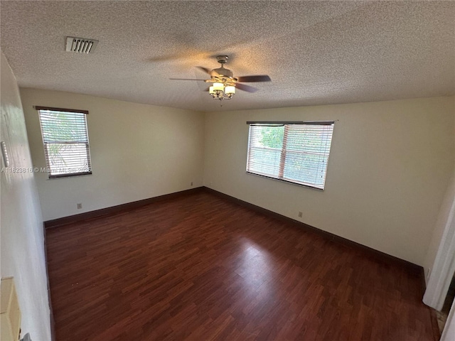 2660 Huron Way, Miramar, FL 33025 - unfurnished room featuring dark wood-type flooring, plenty of natural light, ceiling fan, and a textured ceiling