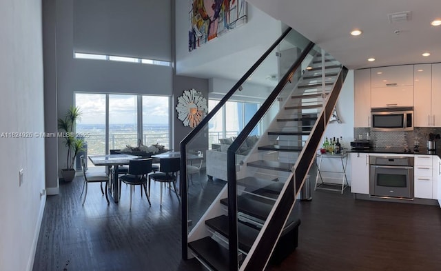 60 SW 13th St Unit 4607, Miami, FL 33130 - stairway with wood finished floors, recessed lighting, and a water view