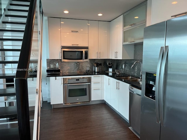 60 SW 13th St Unit 4607, Miami, FL 33130 - kitchen with appliances with stainless steel finishes, modern cabinets, decorative backsplash, dark wood-style floors, and recessed lighting