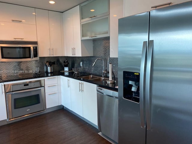 60 SW 13th St Unit 4607, Miami, FL 33130 - kitchen featuring appliances with stainless steel finishes, dark wood-style flooring, white cabinetry, tasteful backsplash, and recessed lighting