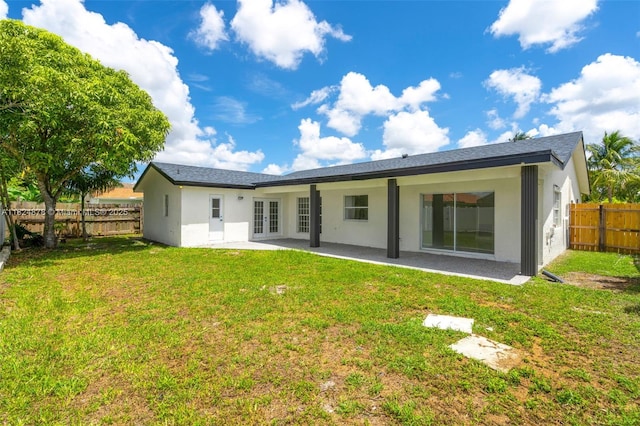 7441 NW 38th Ct, Lauderhill, FL 33319 - rear view of house featuring french doors, a fenced backyard, stucco siding, and a patio area
