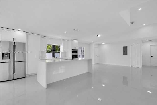 7441 NW 38th Ct, Lauderhill, FL 33319 - kitchen with stainless steel appliances, electric panel, white cabinets, modern cabinets, and light countertops