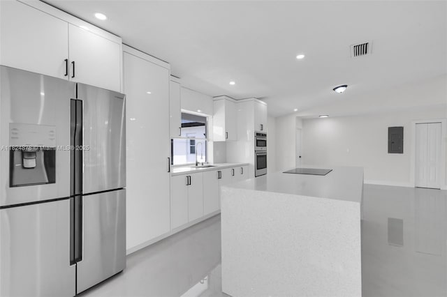 7441 NW 38th Ct, Lauderhill, FL 33319 - kitchen with stainless steel appliances, white cabinetry, modern cabinets, electric panel, and recessed lighting