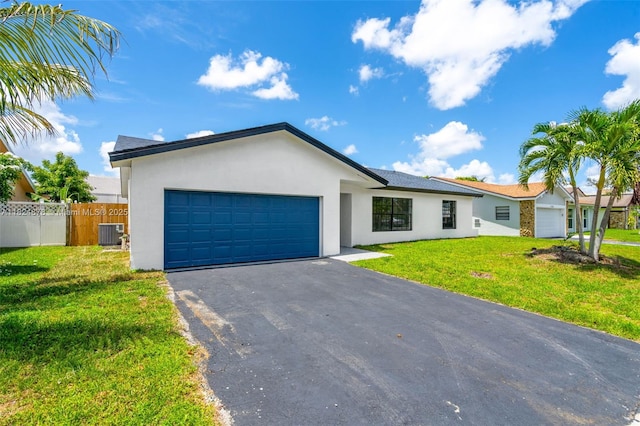 7441 NW 38th Ct, Lauderhill, FL 33319 - view of front of property with a garage, stucco siding, and asphalt driveway