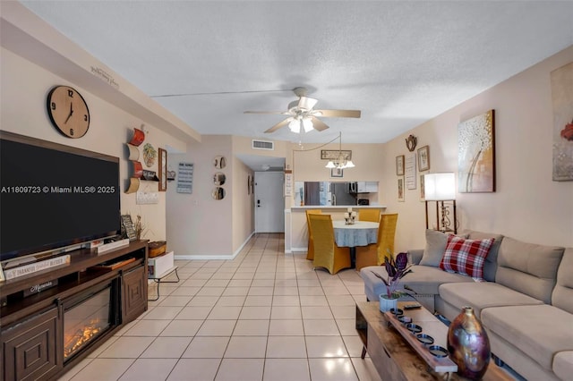 8317 Royal Palm Blvd Unit 104, Coral Springs, FL 33065 - living area featuring a ceiling fan, a textured ceiling, and light tile patterned floors