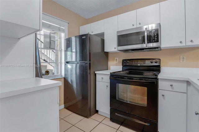 8317 Royal Palm Blvd Unit 104, Coral Springs, FL 33065 - kitchen featuring black appliances, light countertops, white cabinets, and light tile patterned floors