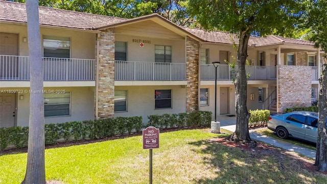 8317 Royal Palm Blvd Unit 104, Coral Springs, FL 33065 - view of front of home featuring stucco siding and a front yard