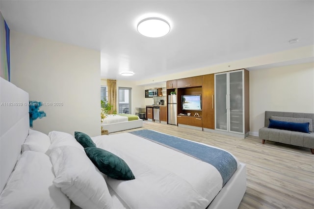 1024 Ocean Dr Unit A202, Miami Beach, FL 33139 - bedroom featuring freestanding refrigerator and light wood-type flooring