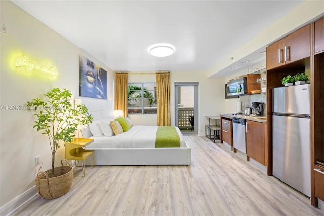 1024 Ocean Dr Unit A202, Miami Beach, FL 33139 - bedroom with freestanding refrigerator, light wood-type flooring, and access to exterior