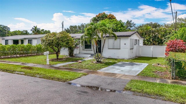 6464 Mcclellan St, Hollywood, FL 33024 - view of front of home featuring solar panels, stucco siding, and a gate