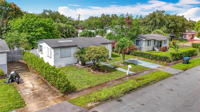 6464 Mcclellan St, Hollywood, FL 33024 - bungalow with concrete driveway, stucco siding, and a shingled roof