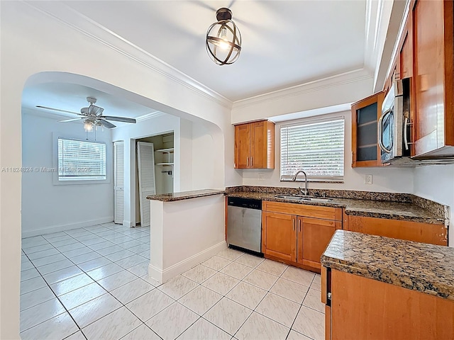 6464 Mcclellan St, Hollywood, FL 33024 - kitchen featuring stainless steel appliances, brown cabinetry, crown molding, healthy amount of natural light, and light tile patterned flooring