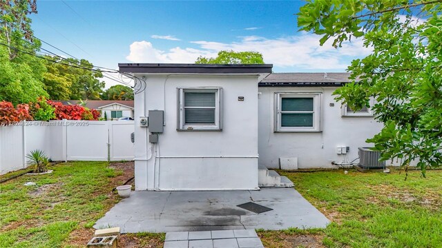 6464 Mcclellan St, Hollywood, FL 33024 - back of property with stucco siding and a gate