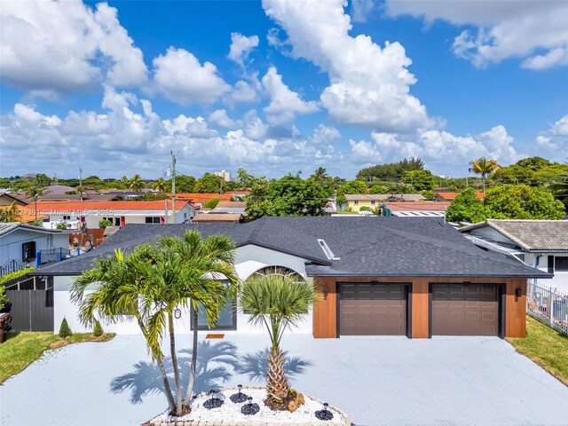 4660 W 8th Pl, Hialeah, FL 33012 - view of front of home featuring a shingled roof, driveway, and a garage