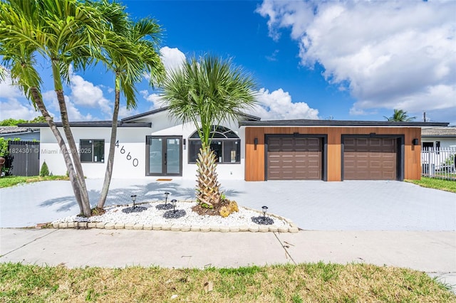 4660 W 8th Pl, Hialeah, FL 33012 - view of front of home featuring french doors, decorative driveway, and a garage