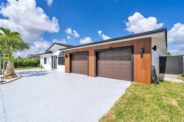 4660 W 8th Pl, Hialeah, FL 33012 - view of front facade with decorative driveway and a garage