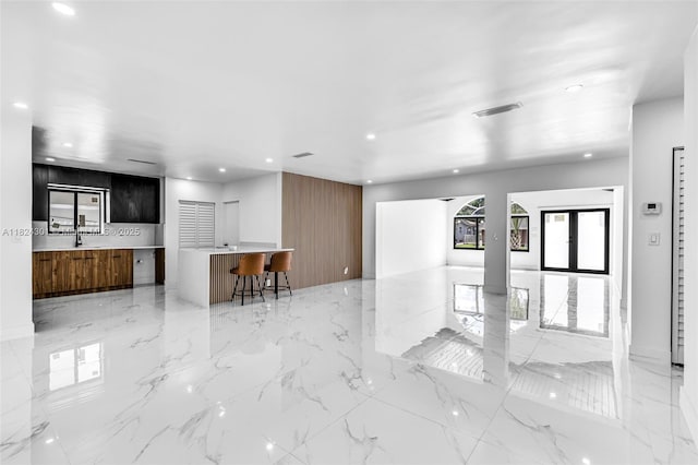 4660 W 8th Pl, Hialeah, FL 33012 - living room featuring recessed lighting and light marble finish flooring