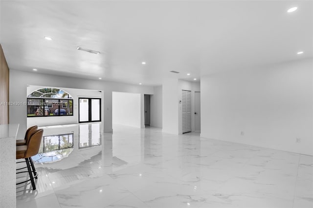 4660 W 8th Pl, Hialeah, FL 33012 - unfurnished living room with recessed lighting and light marble finish floors