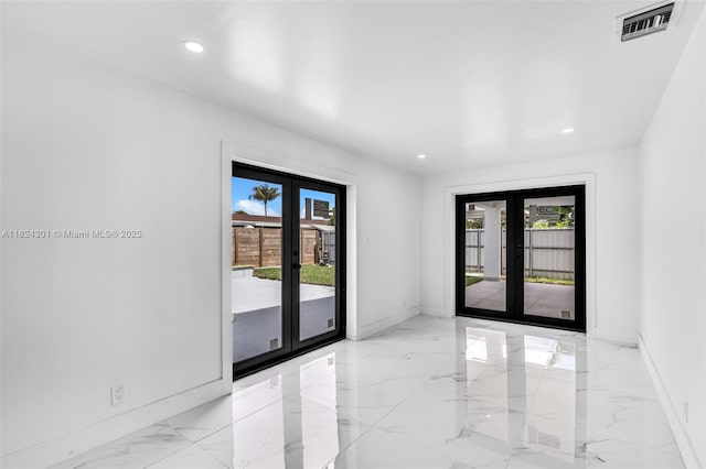 4660 W 8th Pl, Hialeah, FL 33012 - unfurnished room featuring french doors, light marble finish floors, and recessed lighting