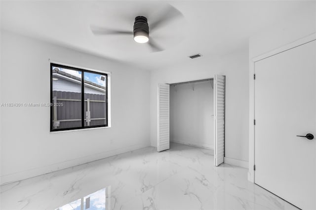 4660 W 8th Pl, Hialeah, FL 33012 - unfurnished bedroom with marble finish floors, a ceiling fan, and a closet