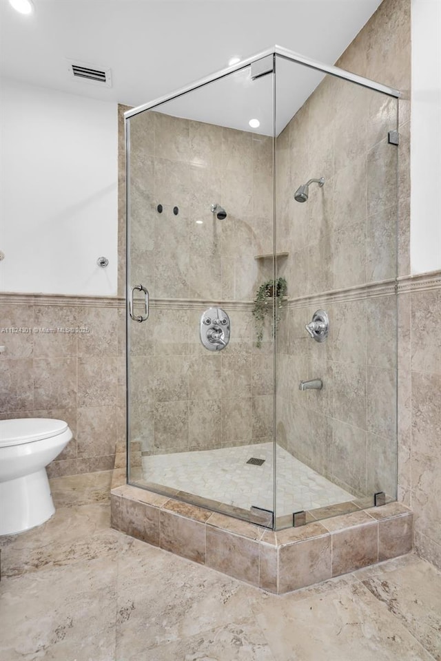 4660 W 8th Pl, Hialeah, FL 33012 - full bathroom featuring a stall shower, tile walls, and recessed lighting