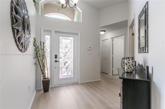 14295 NW 18th Pl, Pembroke Pines, FL 33028 - foyer with light wood finished floors, a towering ceiling, and a chandelier