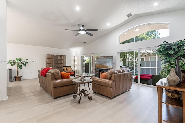 14295 NW 18th Pl, Pembroke Pines, FL 33028 - living room with a fireplace, light wood-style flooring, high vaulted ceiling, ceiling fan, and healthy amount of natural light