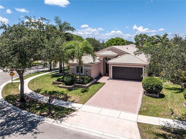 14295 NW 18th Pl, Pembroke Pines, FL 33028 - mediterranean / spanish house with a tile roof, an attached garage, decorative driveway, stucco siding, and a front yard
