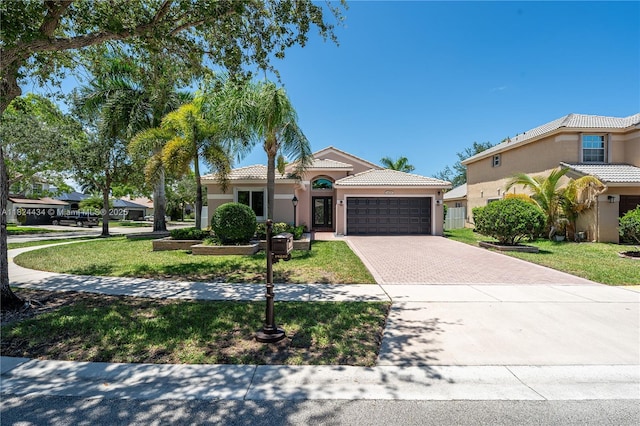 14295 NW 18th Pl, Pembroke Pines, FL 33028 - mediterranean / spanish-style house with stucco siding, driveway, a garage, and a tiled roof
