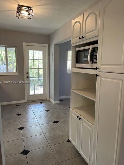 5433 NE 5th Ave, Oakland Park, FL 33334 - doorway featuring baseboards and light tile patterned flooring