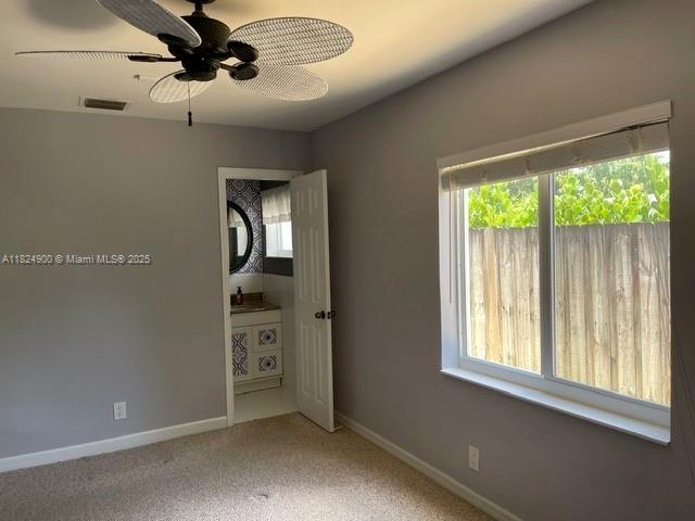 5433 NE 5th Ave, Oakland Park, FL 33334 - carpeted empty room featuring baseboards and ceiling fan