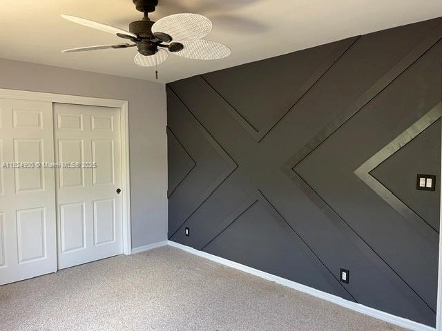 5433 NE 5th Ave, Oakland Park, FL 33334 - unfurnished bedroom featuring a closet, carpet flooring, and ceiling fan